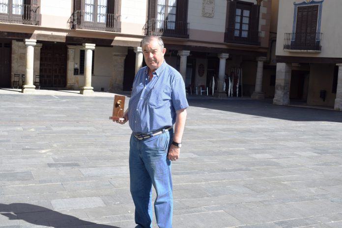 Angel Aventín posa en la Plaza Mayor de Graus con la Amapola de Oro (Fotografía: Angel Gayúbar)
